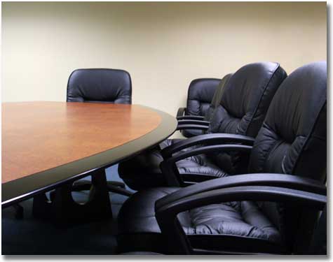 boardroom table with leather chairs